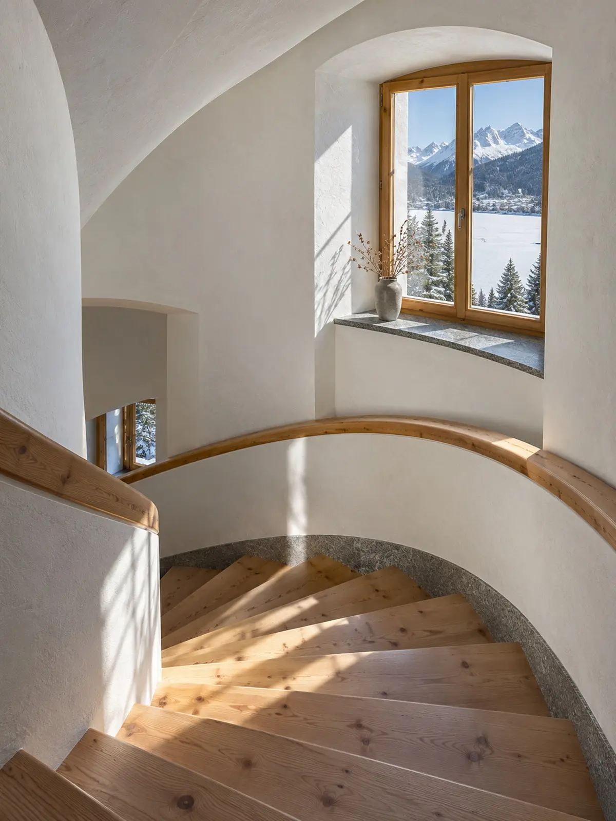 The spiral stone-pine staircase, light falling down the stairwell